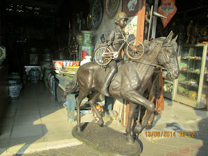 A complex equestrian cast iron statue in a Jakarta antique shop.