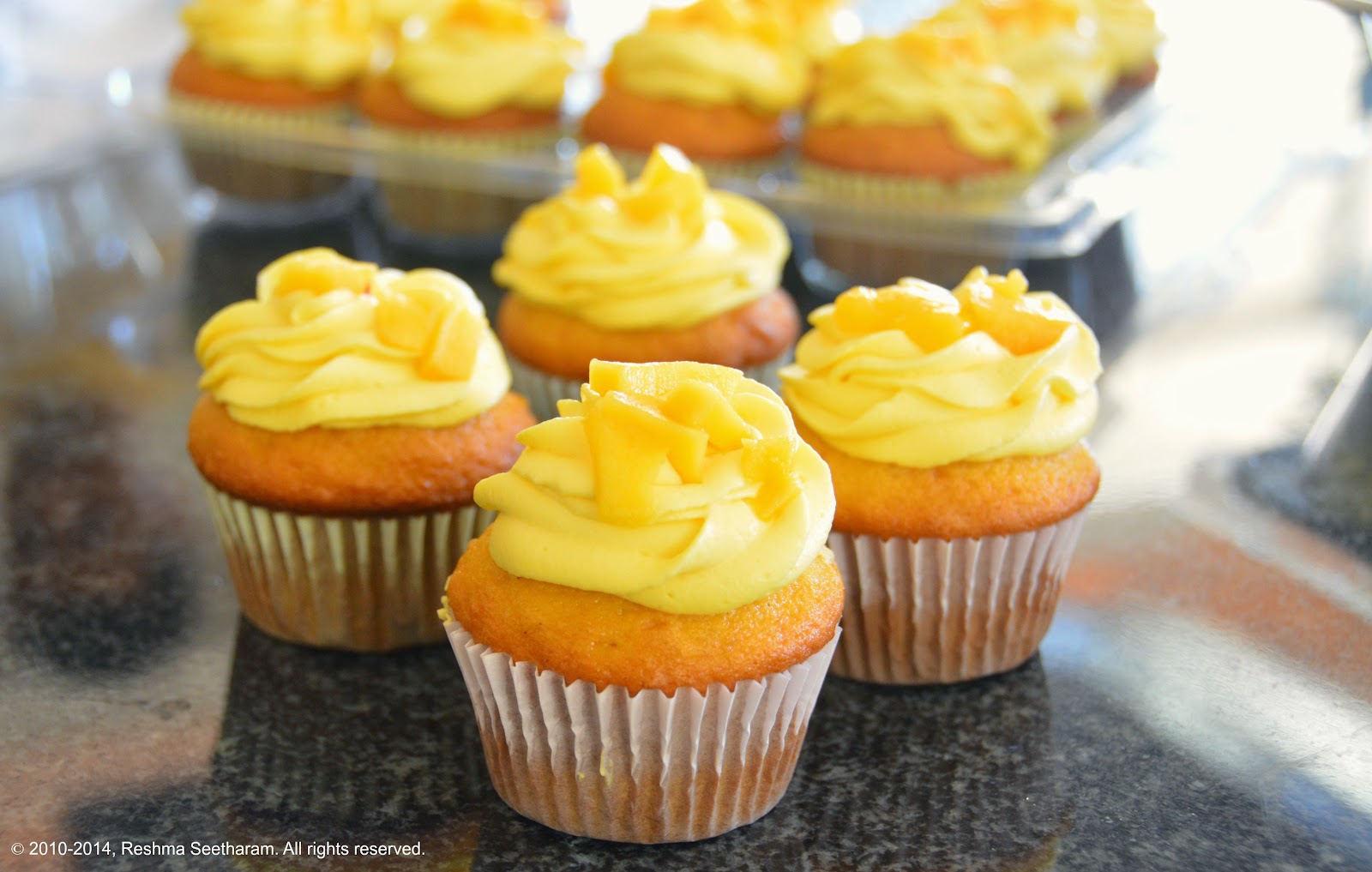 Mango cupcakes filled and frosted with mango cream frosting