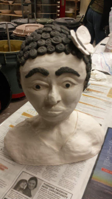 Sculptural clay pottery bust of a Negro woman, in progress.