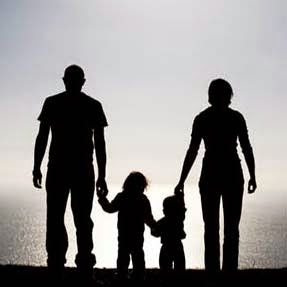 Silhouette of parents and two small children