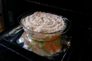 A rhubarb and loquat crumble on an oven tray ready to be baked