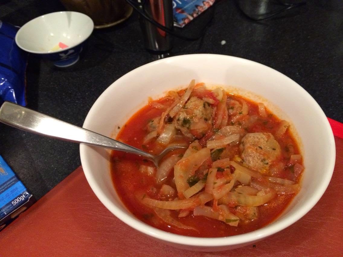 Tomato, Fennel and Pork & Veal Meatball Soup a man in his kitchen