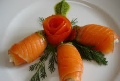 CHEESE CRUMBLED STUFFED SMOKED SALMON FLOWER DISPLAY WITH FENNEL, BASIL LEAVES, TOMATOES