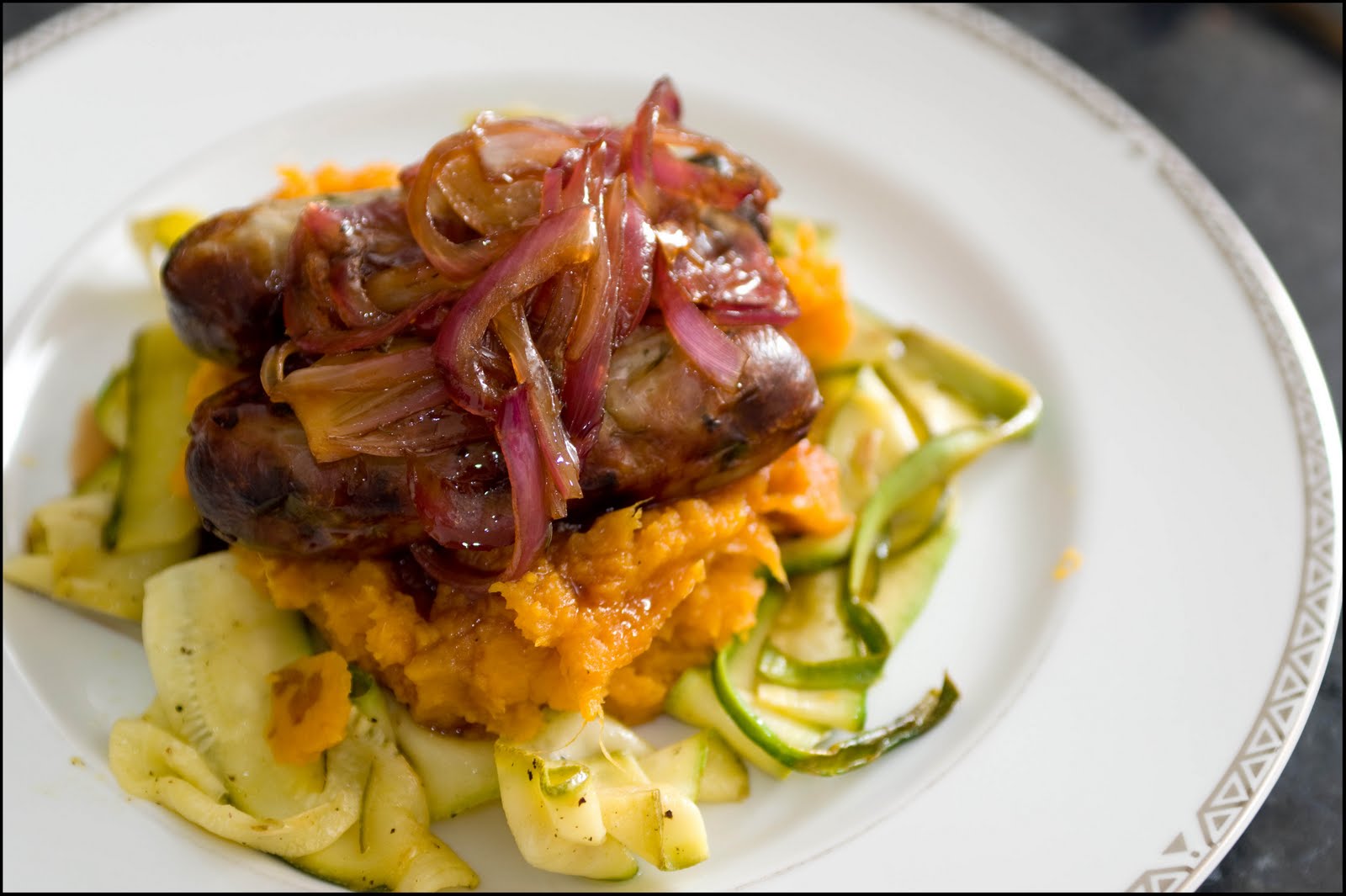 Dinner at Maya's Sausages, Sweet Potato Mash, Onion Relish & Courgettes