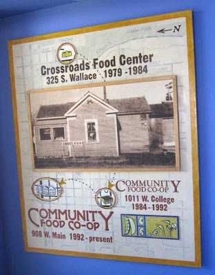 Vertical sign with photo of house that served as first store