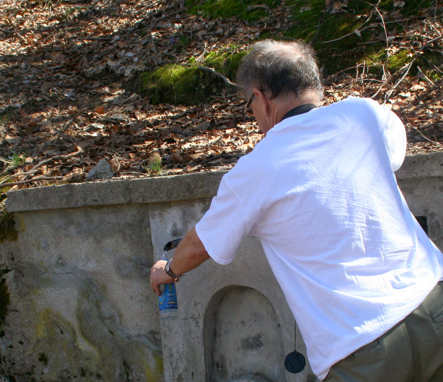Refilling water bottles at the track side spring Refilling water bottles at the track side spring