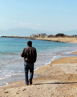 Alone boy walking near sea