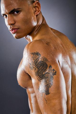 Good looking Latin male with dragon tattoo on his arm