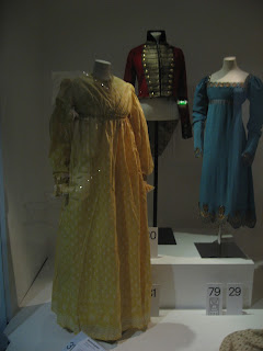 1815 fashions. The yellow print calico gown is c.1815; man’s woollen uniform same 