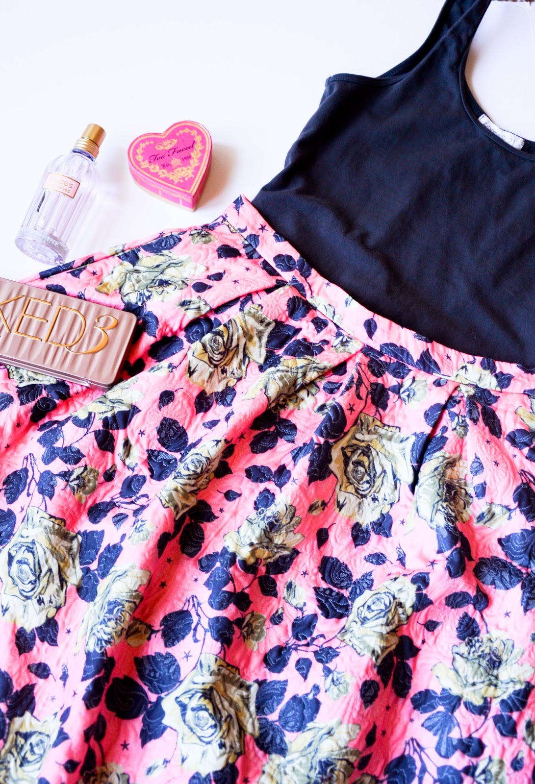 Beauty essentials: L'occitane roses perfume, Too faced heart shaped blush, Urban decay naked 3 eye shadow pallet, pink and gray floral midi skirt from forever21