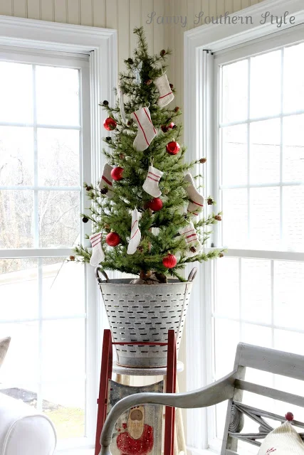 Sweet little Christmas tree inside an olive bucket, by Savvy Southern Style, featured on I Love That Junk. Check out this tour for more!