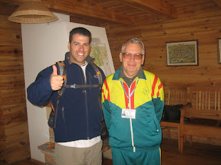 a man giving a thumbs up with another man in a room