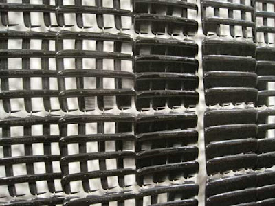 Close up of the portrait, showing that it's made of black plastic combs