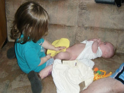 Sasha helping with Spencer's diaper change
