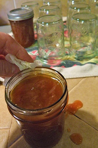 Hand with Towel Wiping off Jar Rim