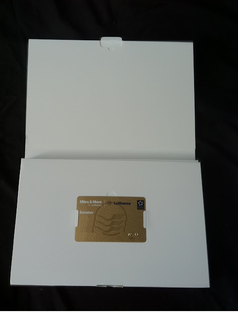 a white box with a gold card in it