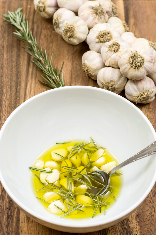 Garlic and rosemary in olive oil close