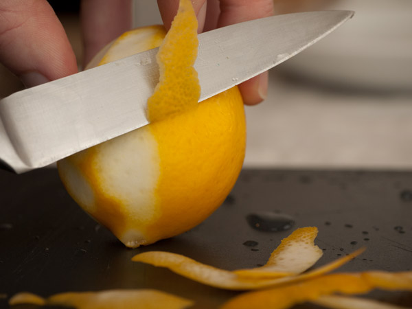 Cutting lemon zest and peel with a knife