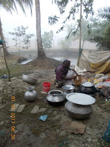 Preparing "Hot Water" for the resort guests in the open air  fire-wood furnace.