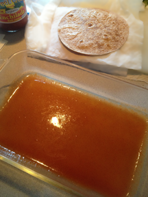Sauce in the bottom of the baking dish and steamed tortillas. Prepping the for Light & Easy Enchiladas. 