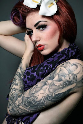 woman with face arm tattoo