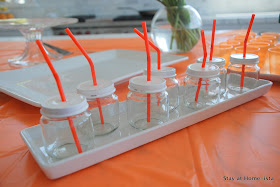 baby food jars with white lids and orange straws