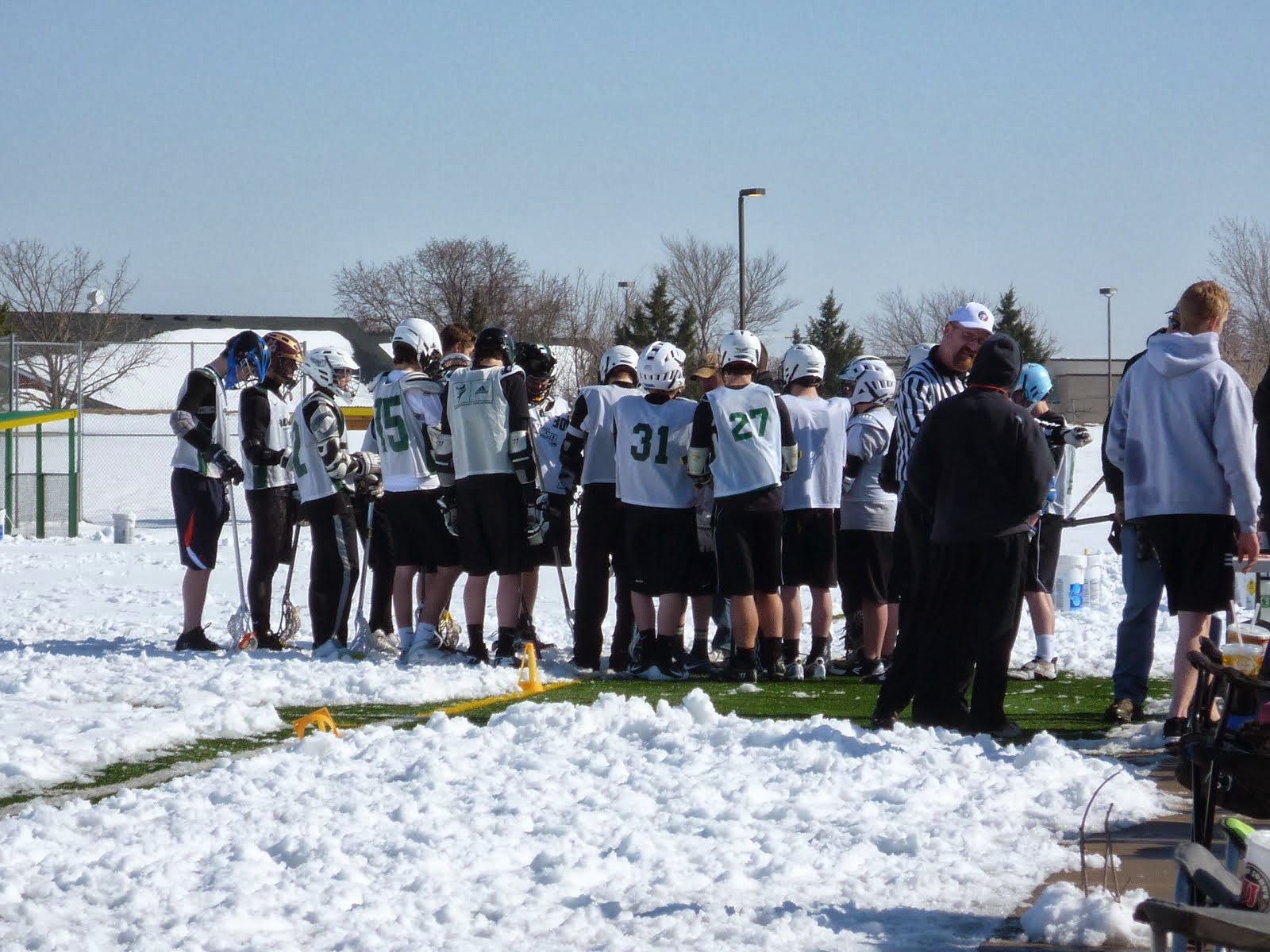 Lacrosse team getting ready to play in the snow. Dawson is #27.