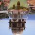 a tower reflection in a glass of wine