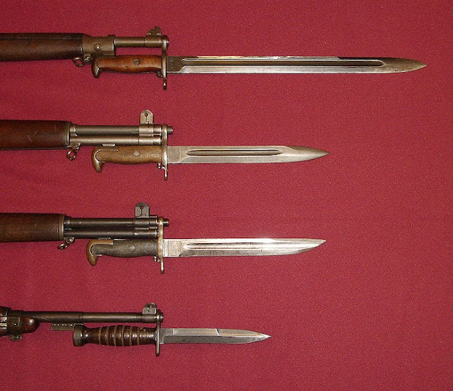 U.S. military bayonets; from the top down, they are the M1905 Bayonet, M1 Bayonet, M1905E1 Bowie Point Bayonet (cut down version of the M1905), and the M4 Bayonet for the M1 Carbine.