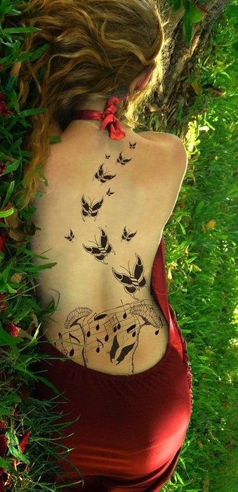 Butterfly and music tattoo on full back