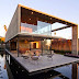 SAN DIEGO CONCRETE HOUSE DESIGN WITH THE INTERIOR AND EXTERIOR LIVING SPACES ALMOST EQUALLY DIVIDED