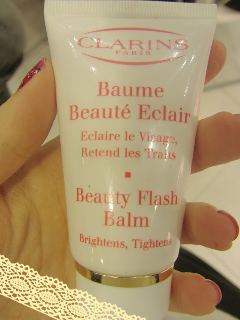 A picture of Beauty Flash Balm by Clarins being held by Roxy