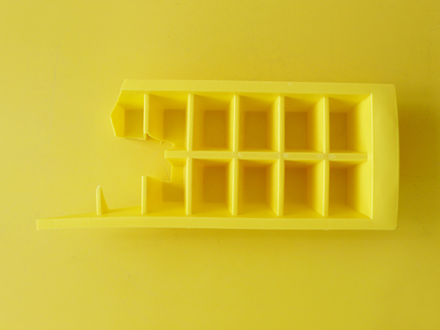 Most of an yellow ice tray.