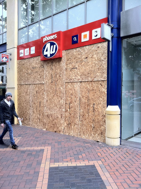 a man walking past a storefront