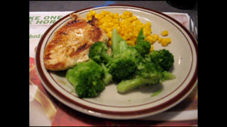 Grilled chicken with corn and broccoli.