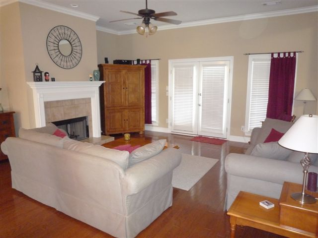 Great Room with double doors to Back Yard & covered patio; wood-burning fireplace with gas starter