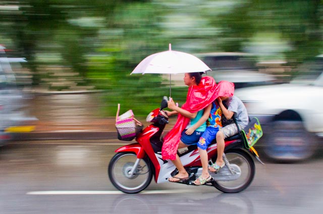 Laos+Mom+Kids+Ride+Moto+in+Rain.jpg