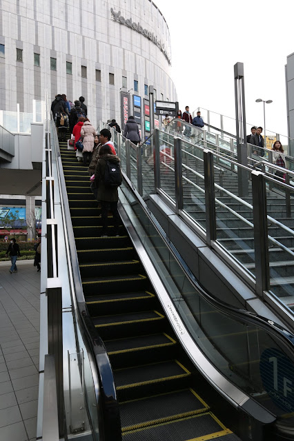 Standing on the right of escalator in order to give way for people who are on the quick move in Osaka, Japan Standing on the right of escalator in order to give way for people who are on the quick move in Osaka, Japan