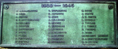 Greeny bronze plaque with raised names, listed in text below.