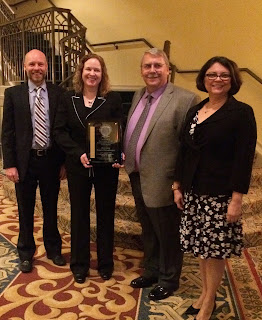 Posing with the Gold Medal in Research are (l to r) Dr. William Wells, Capt. Lori Bender, Sgt. Steven Morrison and Executive Assistant Chief Martha Montalvo.