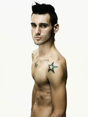 Black shoulder star tattoo on good looking male's