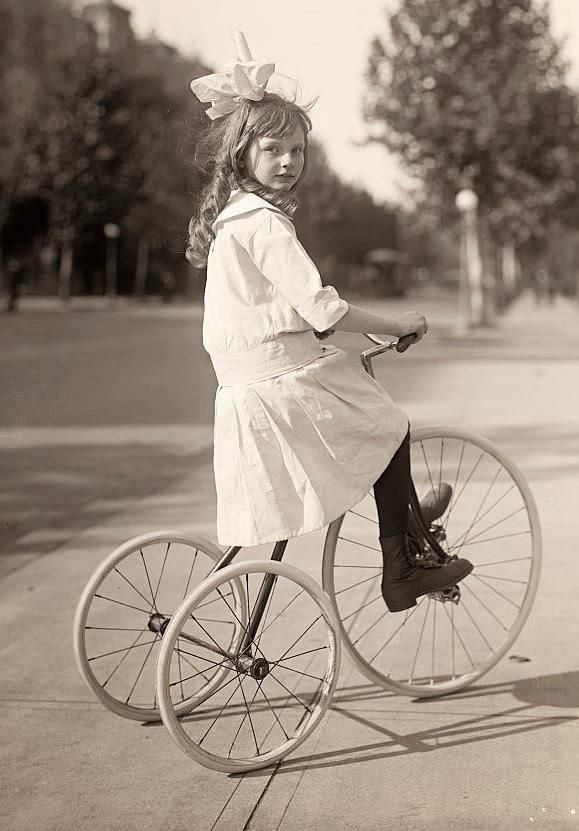 girl riding tricycle