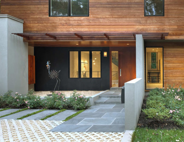 Grey Colored Floor Made from Concrete Blocks and Bright Cream Lighting from Inside the House