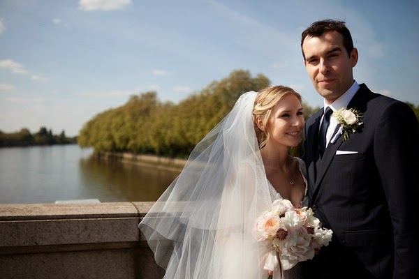 Bride and groom on the thames bridge London Wedding at All Saints Church in Fulham 