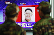 . watching television coverage of North Korean leader Kim Jong Il death. (kim jong il dead ckim jong il dead ckim jong il died ckim jong il death ckim jong il died pictures)