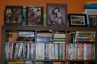 picture frames on bookshelf over dvds