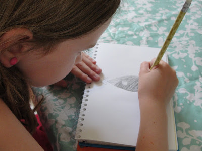 child sketching a fish