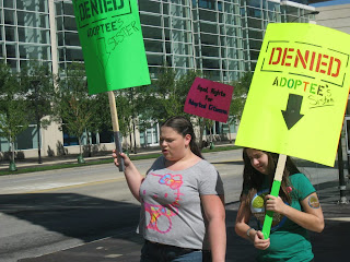 Sisters of adopted brothers demonstrating adoptee rights