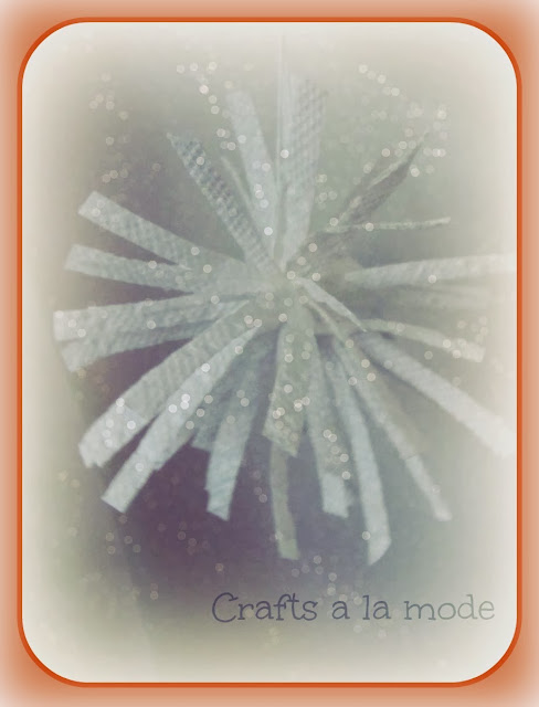 fake snowflake made with paper towel strips and glitter