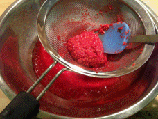 Raspberries juiced in a mesh sieve Raspberries juiced in a mesh sieve